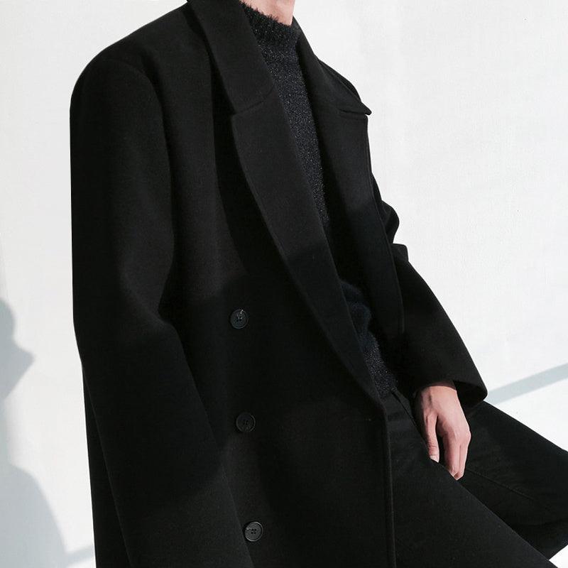Black double-breasted wool coat with notch lapels and dark button detail
