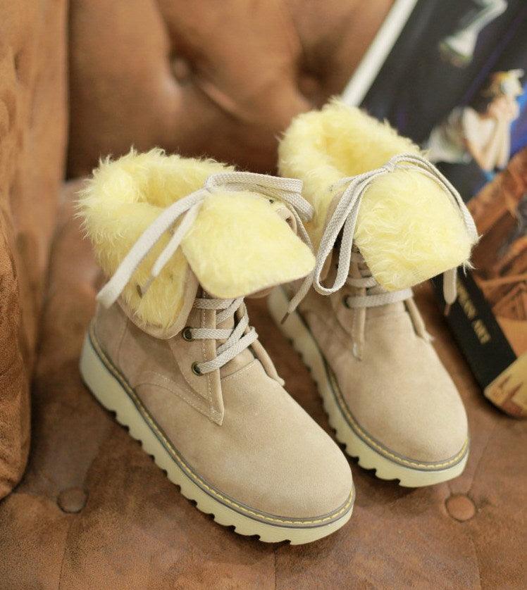 Cream faux fur lace-up snow boots with tied ankle laces and contrast trim