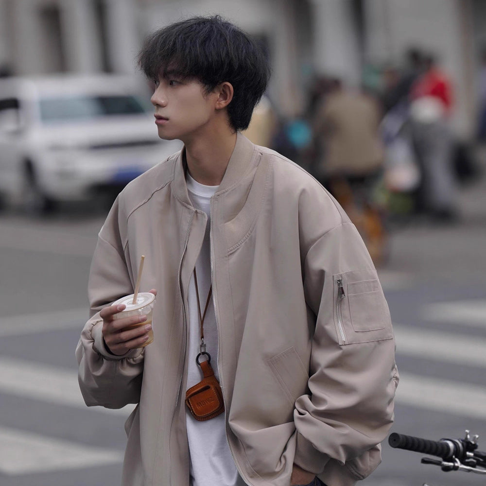 Men's loose pilot jacket in light tan, zip front, stand collar, side pockets, sleeve zip.
