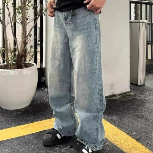 Light blue loose-fit straight-leg denim trousers with drawstring waist and side pockets