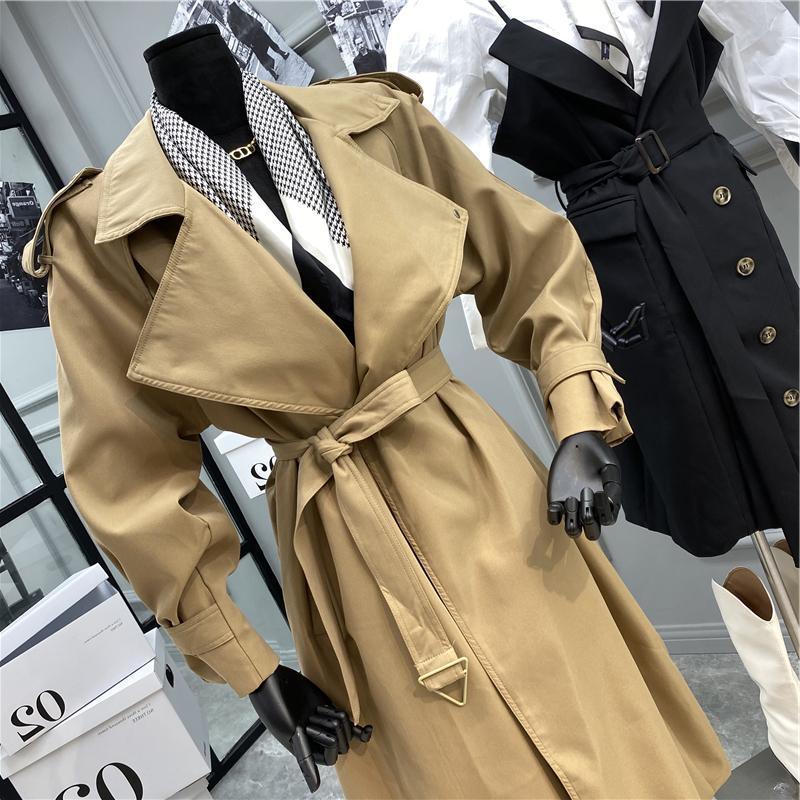 Beige over-the-knee belted trench coat with notched lapels and cuffed sleeves