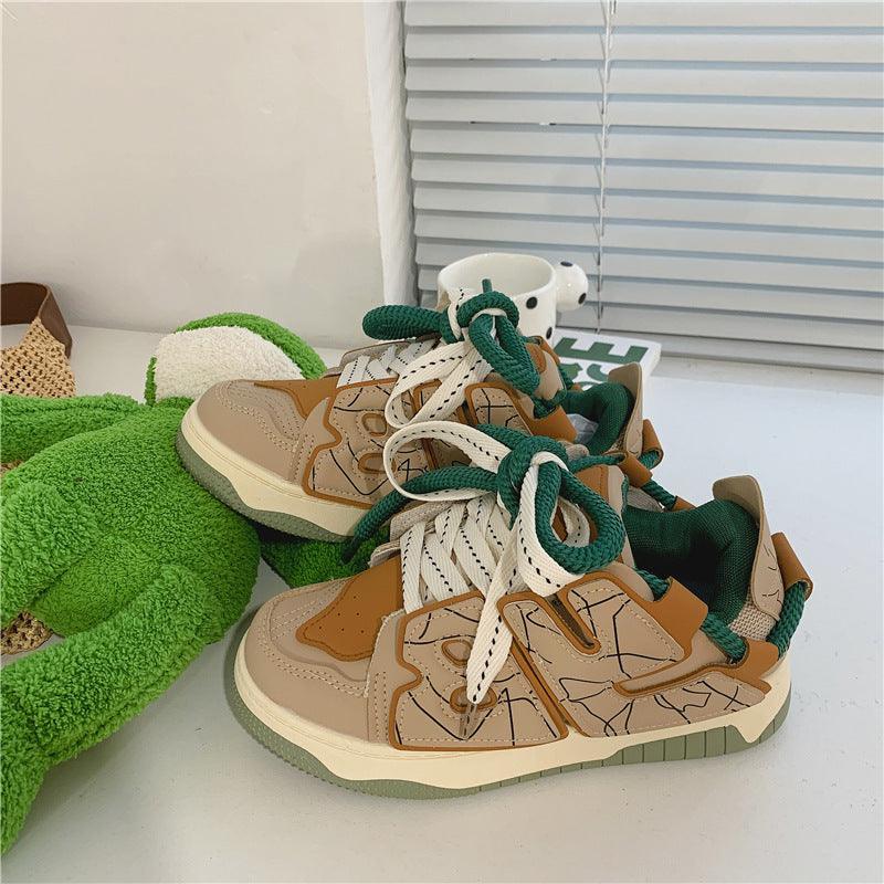 Women’s casual sneakers, cream uppers with brown accents and green lace eyelets