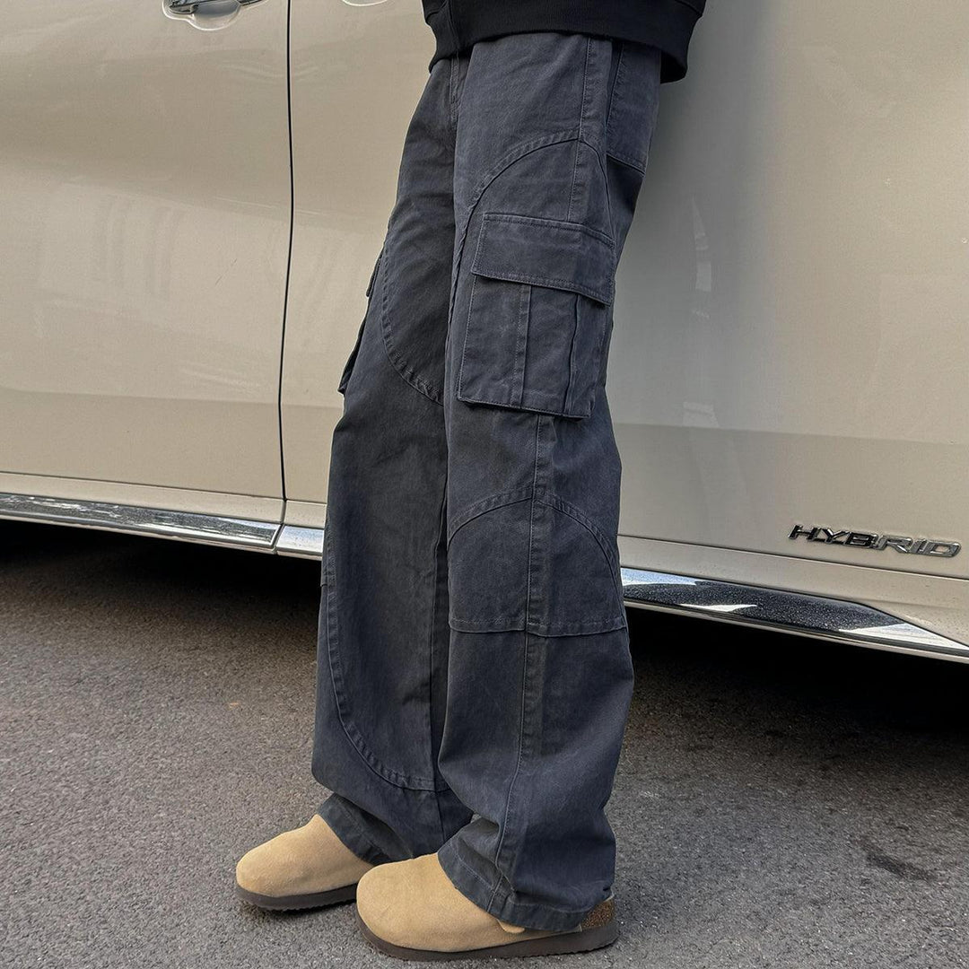 Dark gray loose-fit cargo pants with wide legs and side cargo pockets