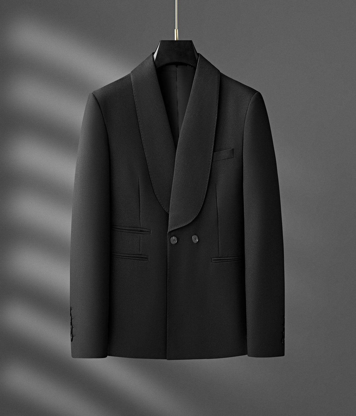 Black single-breasted small suit jacket on hanger with flap pockets and double buttons
