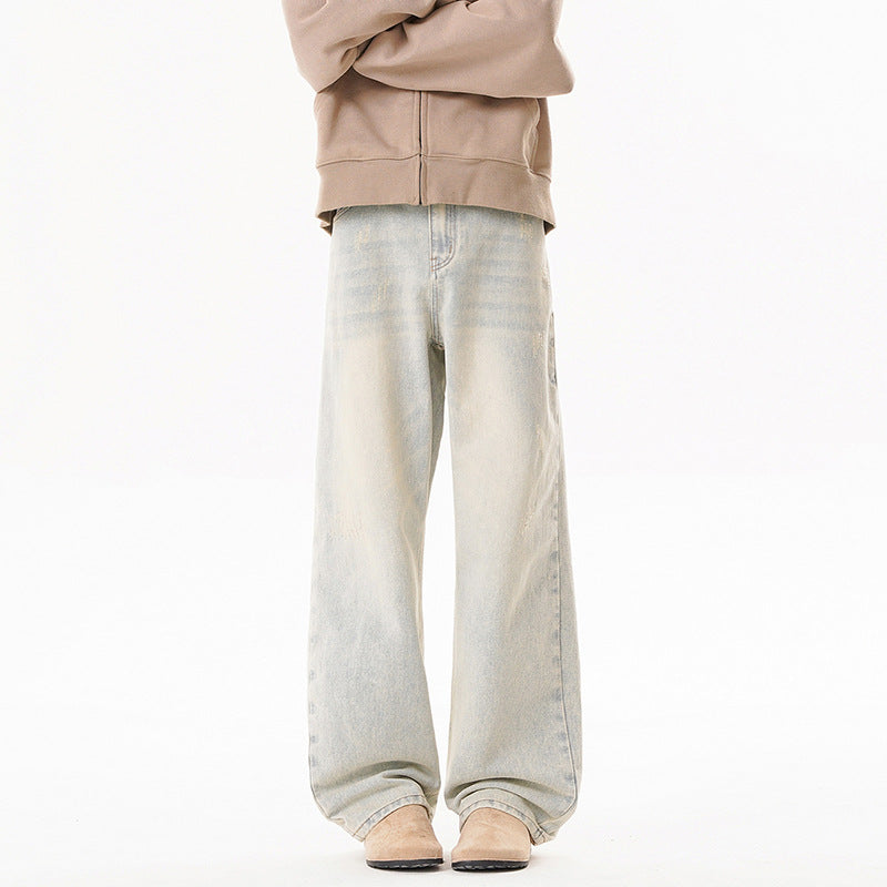 Men's pale light-wash distressed jeans with loose wide legs and faded finish
