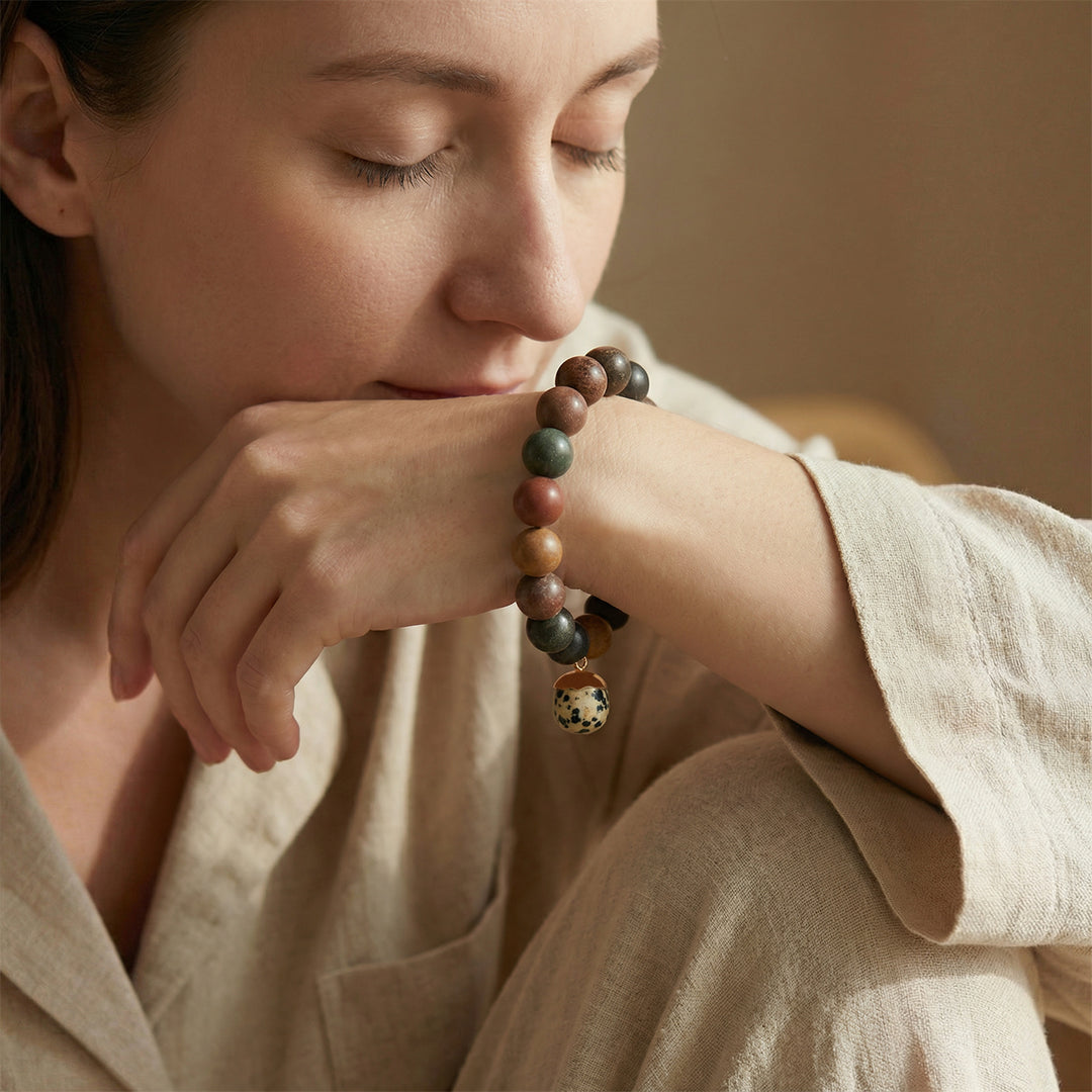Beaded herbal bracelet with multicolor round stones and a small dangling charm