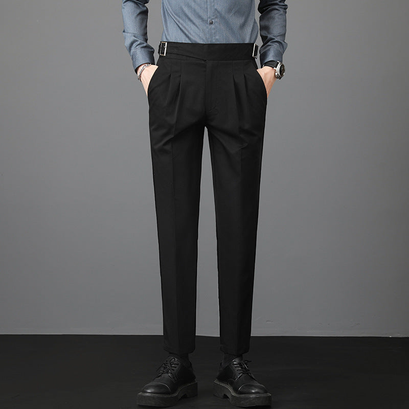 Slim-fit young men’s suit trousers in black, flat front, belt loops, tapered leg.