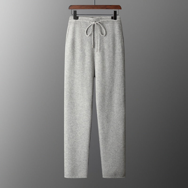 Light gray wool trousers with high waist, loose fit, and drawstring tie at front