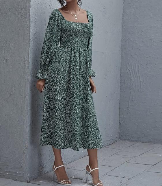 Women's green patterned midi dress with long sleeves and gathered skirt