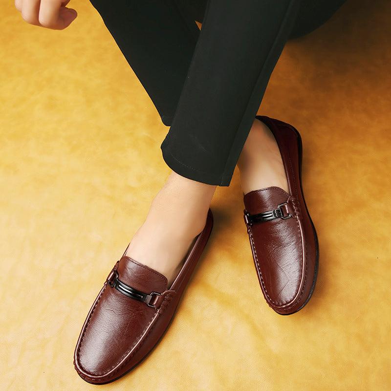 Dark brown leather loafer with metal buckle strap and moc-toe stitching