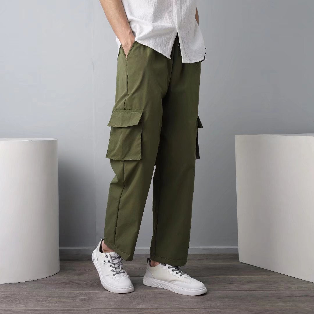 Men's military green cargo pants with side flap pockets and relaxed straight fit