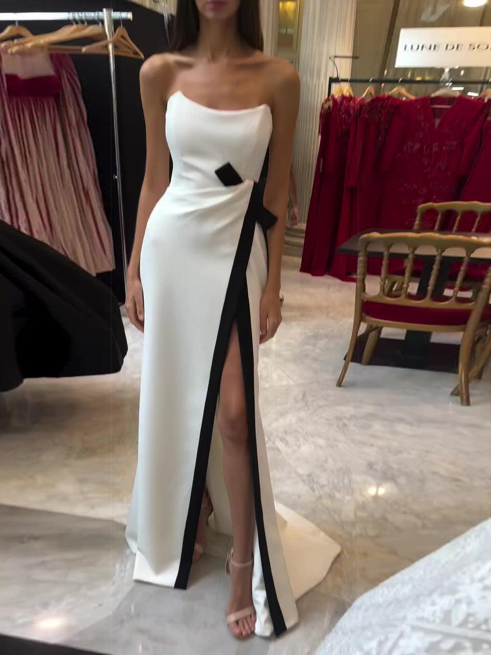 Strapless white slit evening dress with black ribbon accents and bow