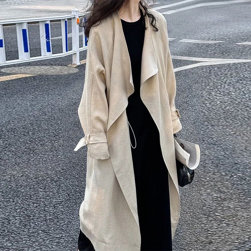 Light khaki trench coat with wide lapels and long sleeves, open front and cuff tabs