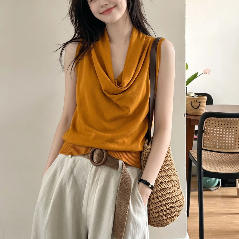 Orange halter top with draped cowl neckline and ribbed hem, sleeveless