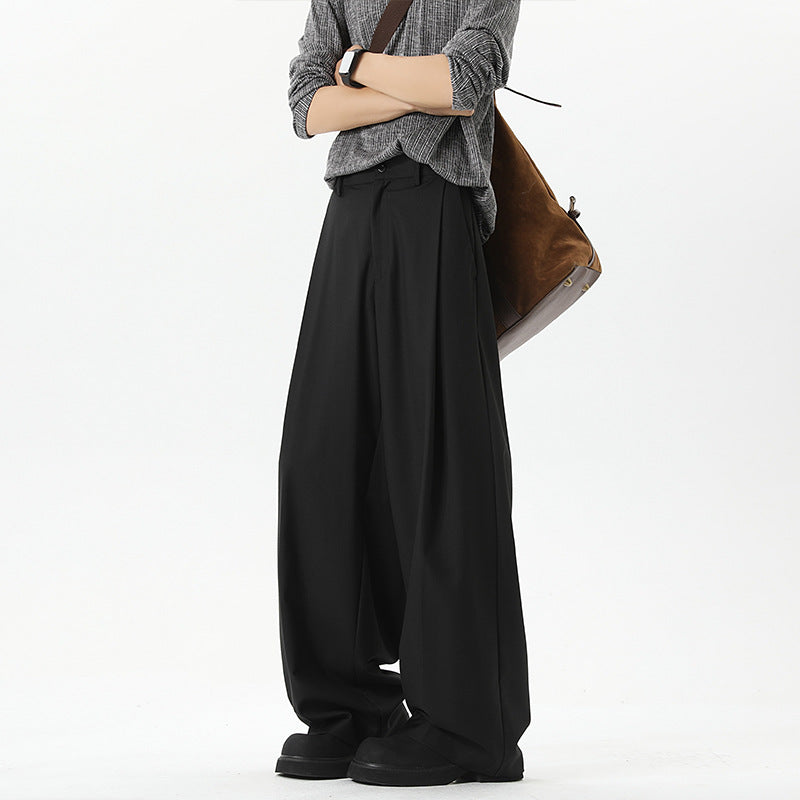 Black straight-leg suit pants with relaxed pleats and wide trouser legs