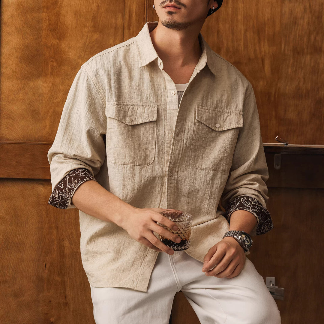 Men's light beige linen button-up shirt with two chest flap pockets and long sleeves