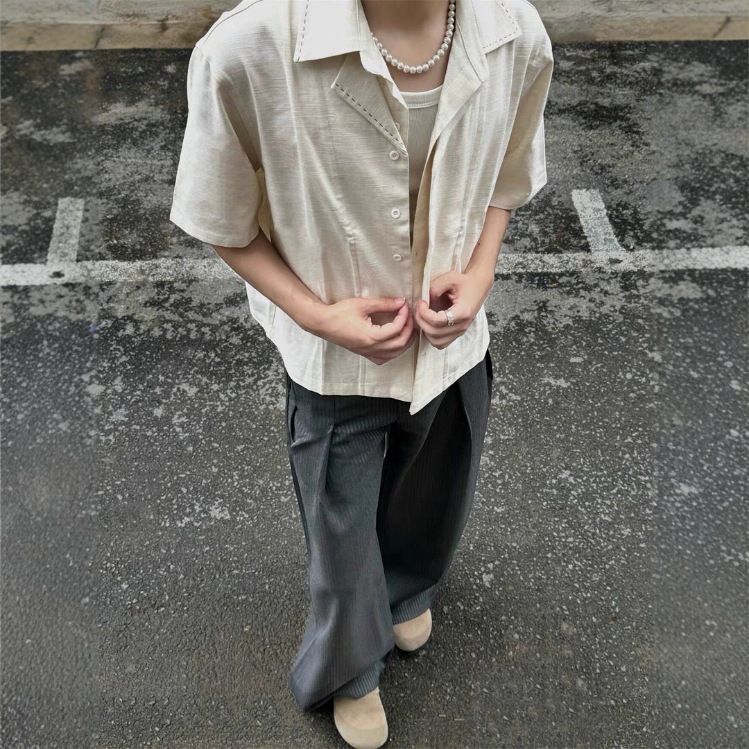 Apricot short-sleeve button-up shirt with pointed collar and chest patch pockets