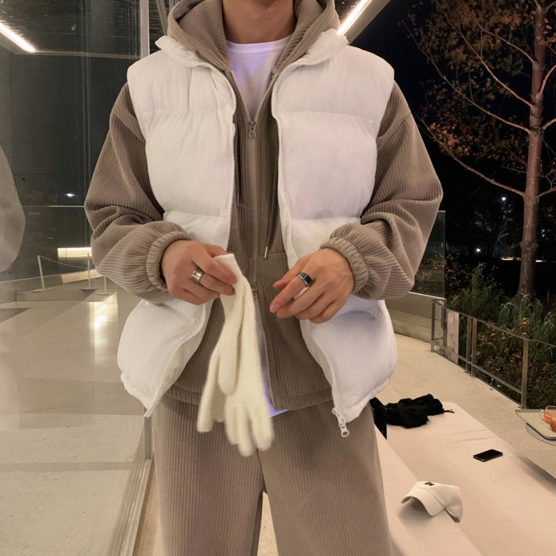 Beige padded zip-up sleeveless vest with stand collar, worn over hoodie sleeves