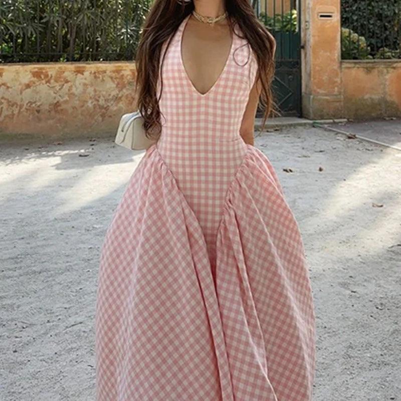Pink gingham V-neck halter dress with pleated full skirt and fitted waist