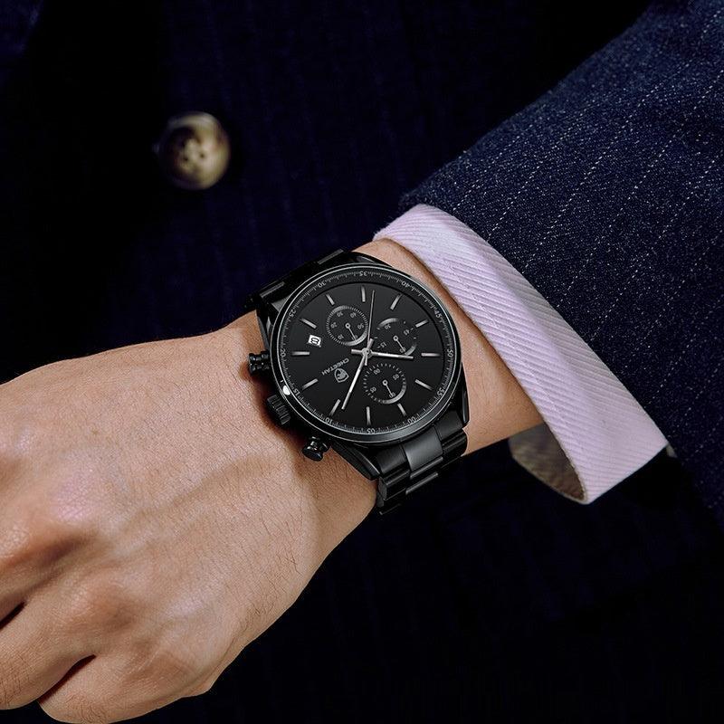 Black multi-dial quartz watch with metal bracelet on wrist and light fabric strap