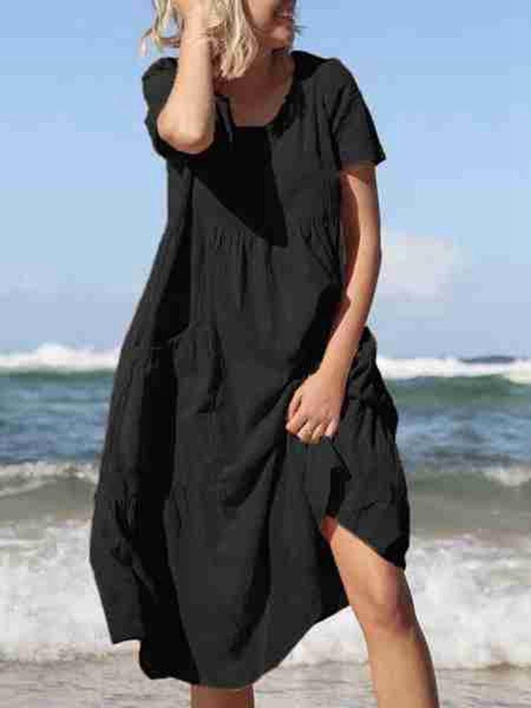 Black loose round-neck dress with short sleeves and side pocket detail