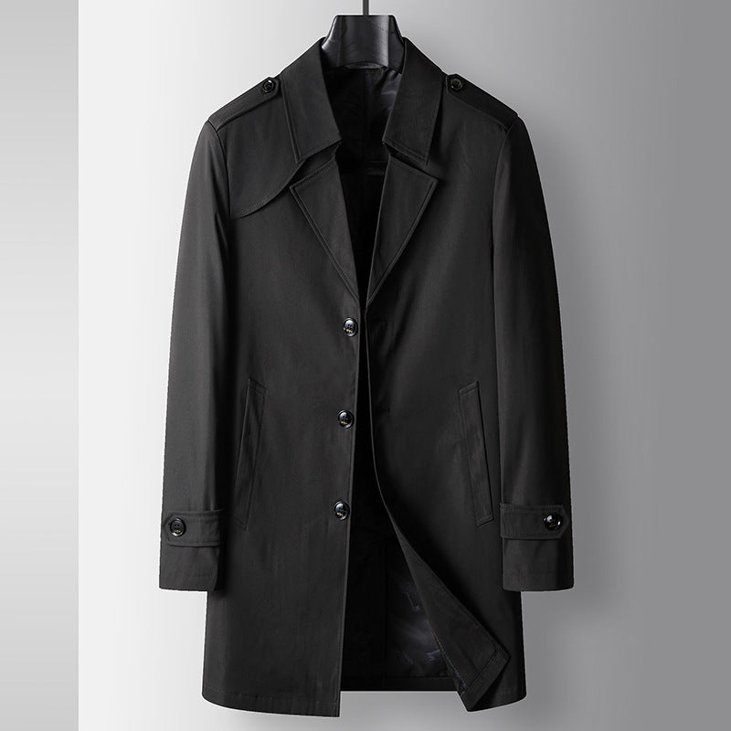 Black youth trench coat with button closures, notched lapels, epaulettes, and side flap pocket