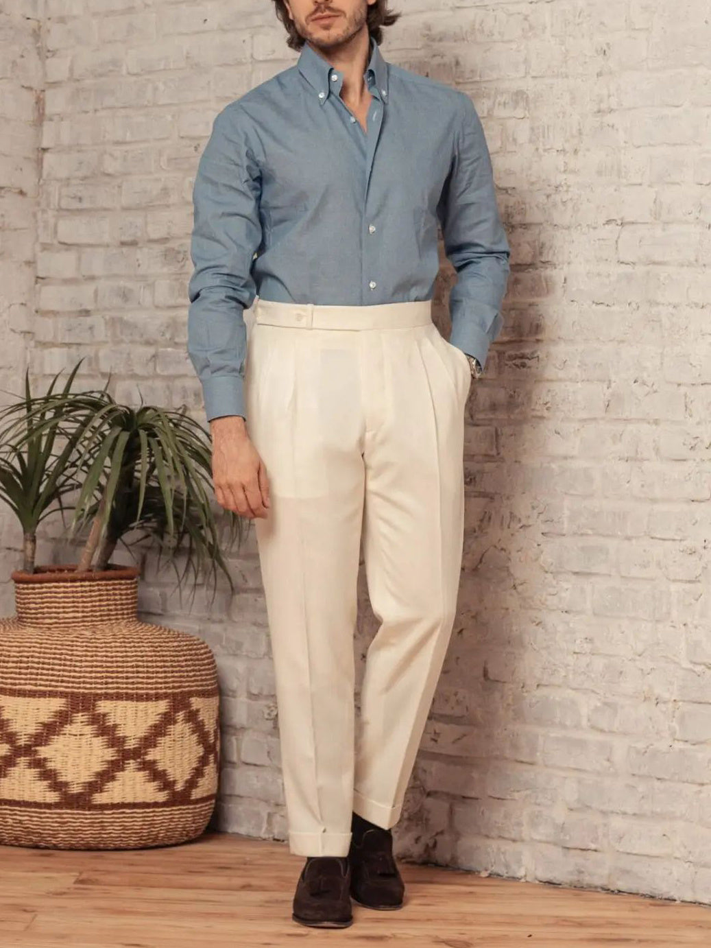 Men's cream solid button pants with pleated front, belt loops, and side pockets