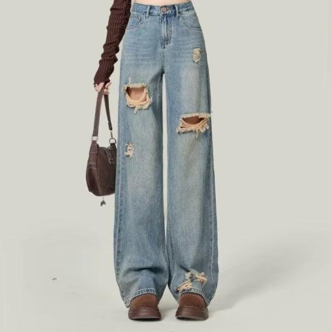 Light blue high-rise wide-leg jeans with thigh rips and frayed knee openings