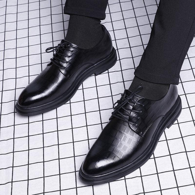 Black leather lace-up oxford-style dress shoes with low-profile rubber sole.