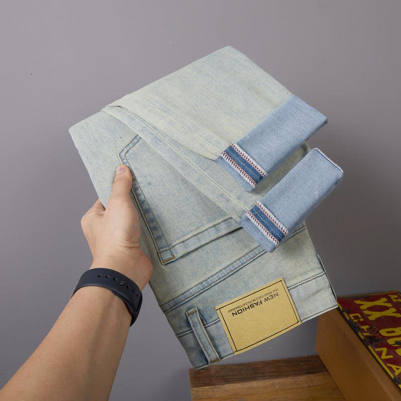 Light blue jeans folded cuff with ankle ties and colorful trim along the hem