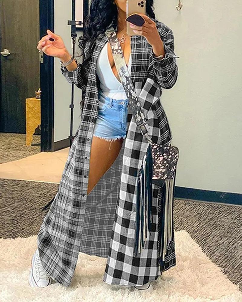 Long open-front plaid coat with fringed hem, black, white, and gray check.