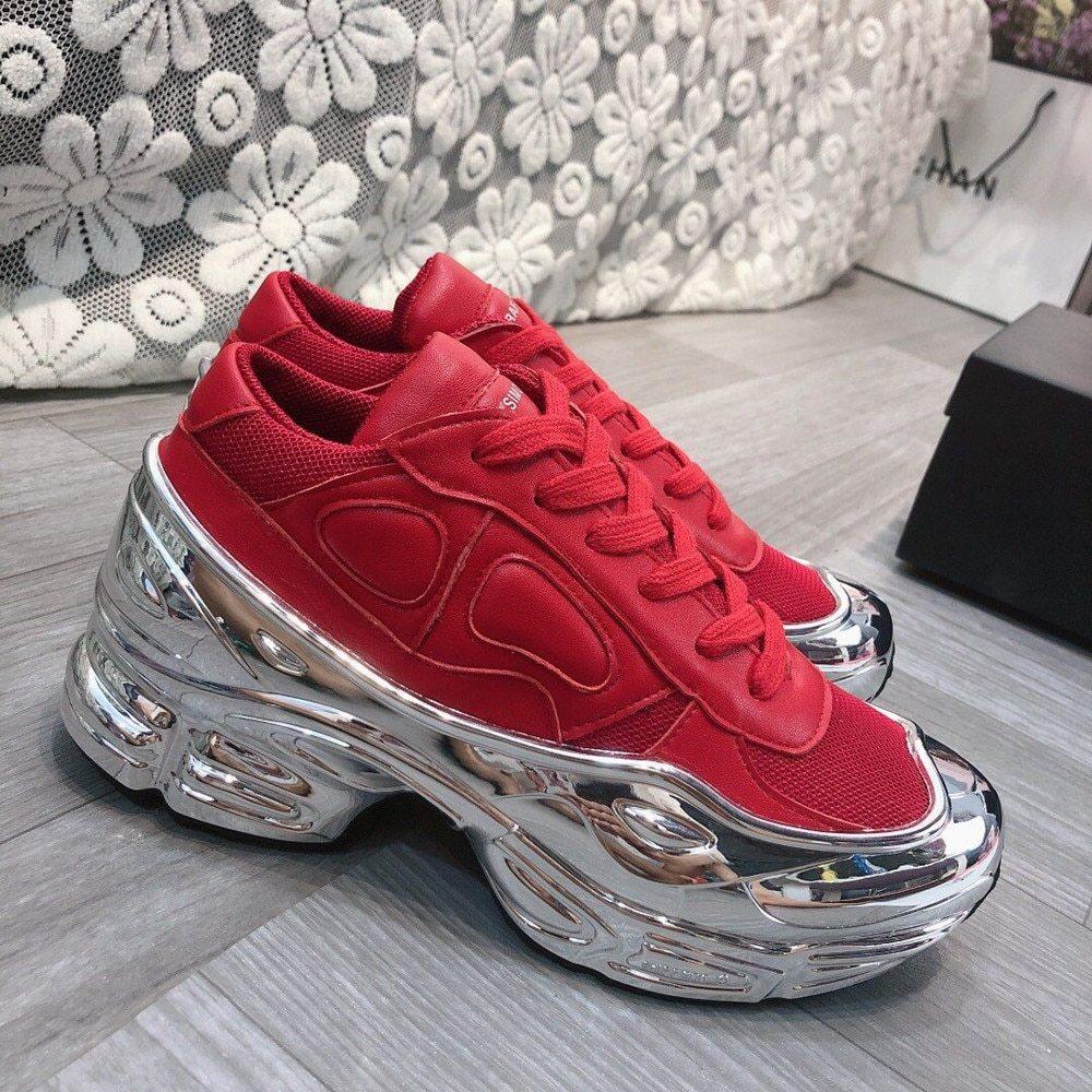 Red lace-up chunky sneakers with metallic chrome platform sole and textured side accents