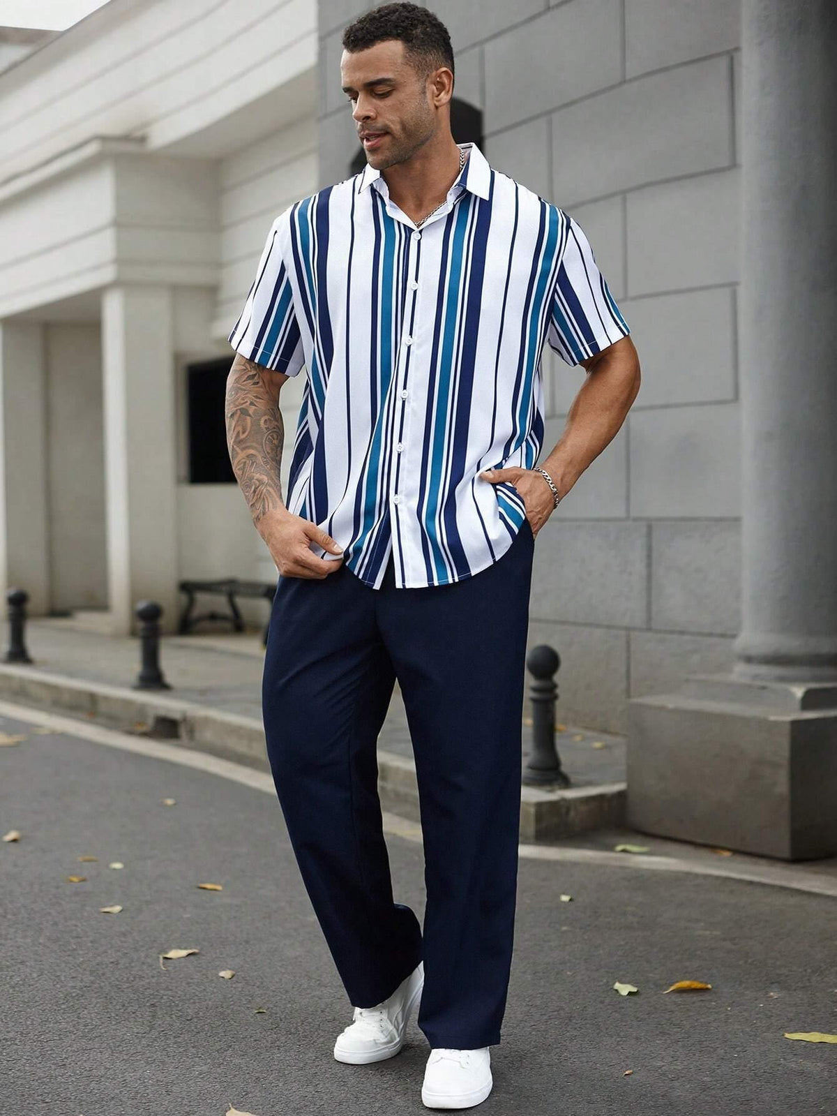 Striped short-sleeve shirt and dark navy trousers set, button-front, vertical stripes.