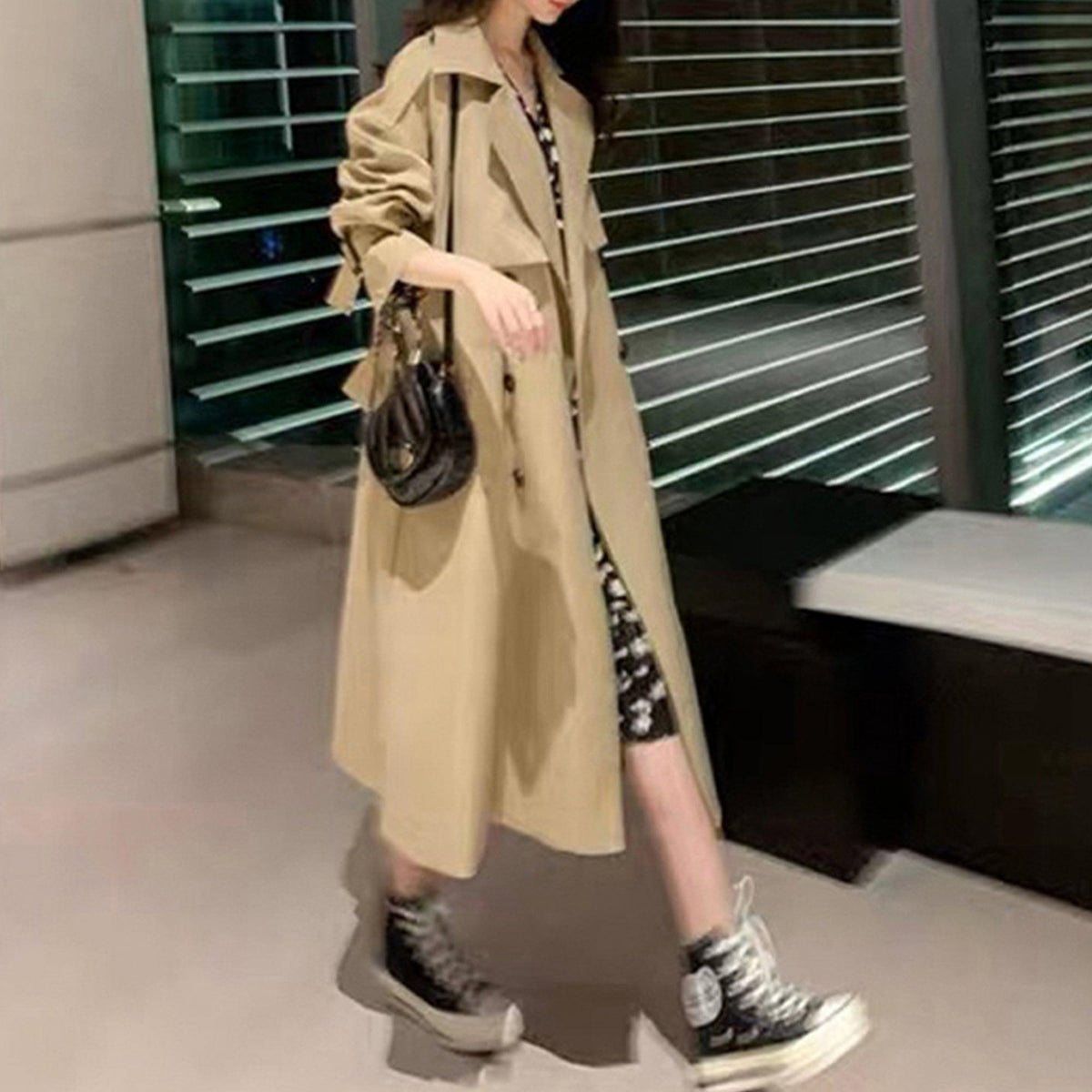 Women’s tan trench coat with belted waist, notched lapels, and long sleeves