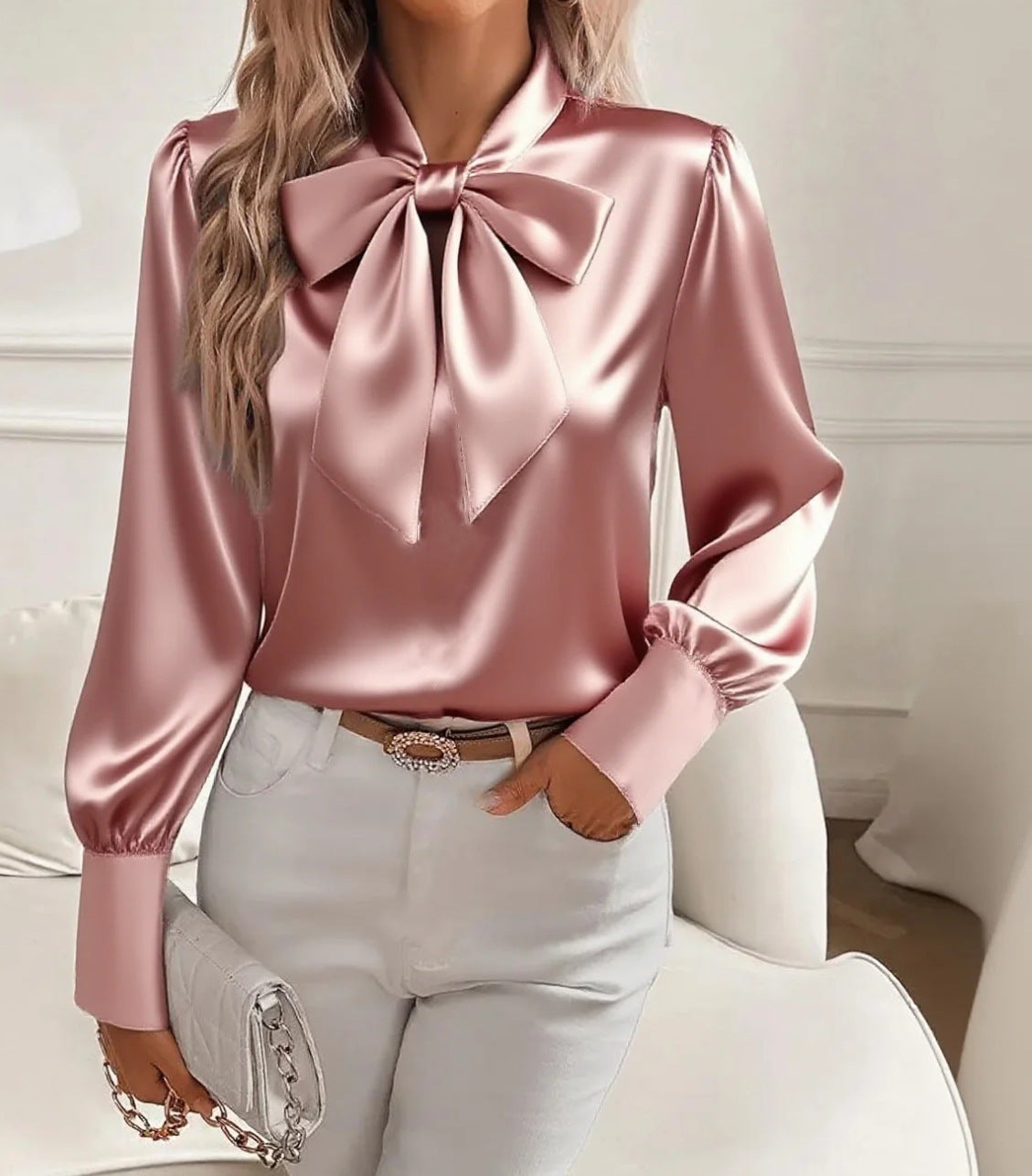 Rose-pink satin long-sleeve pullover top with large bow tie at the neckline