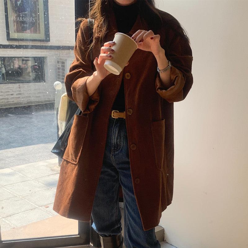 Brown corduroy coat with button front, notched lapels, and flap pockets