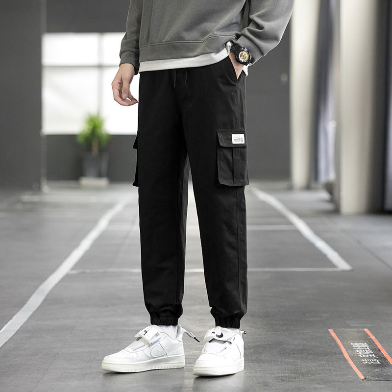 Men's black cargo jogger pants with flap cargo pockets and tapered cuffed legs