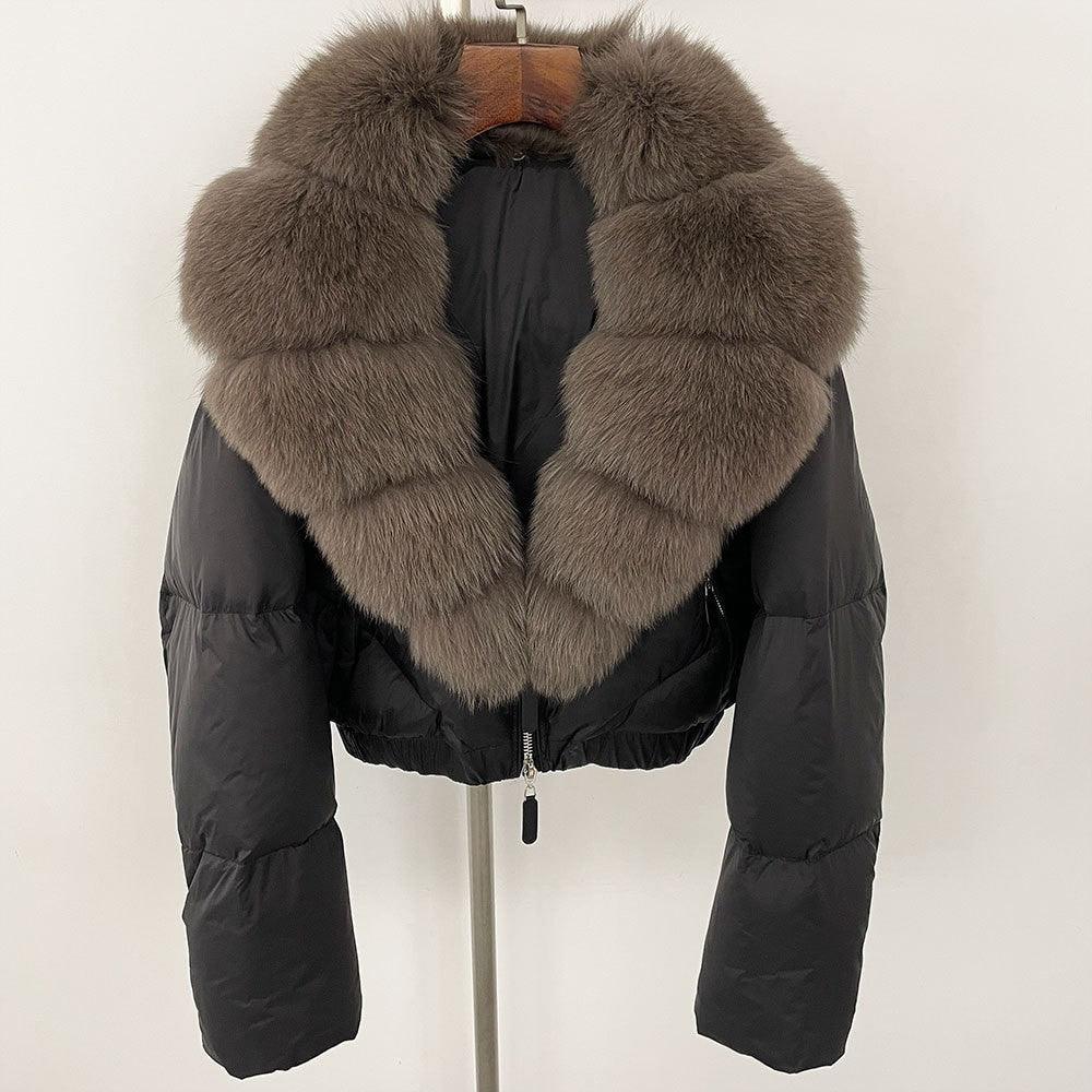 Short puffer down jacket with thick gray fox fur collar and front zipper, black exterior.