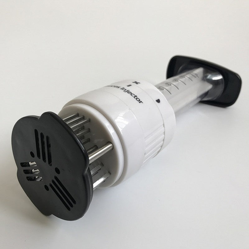 Manual meat injector with black suction plate, metal needle stems, and white body