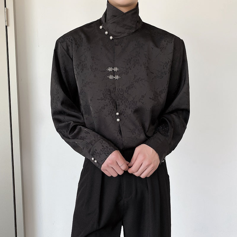 Black long-sleeve stand-collar shirt with decorative front motif and pearl-like button row