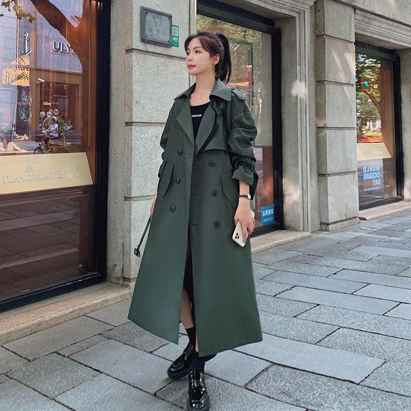 Army green double-breasted trench coat with belt, notched lapels, and front buttoning