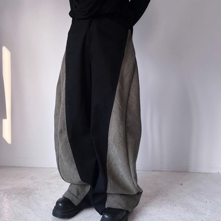 Black wide-leg pants with curved paneling and relaxed straight cut, front pockets