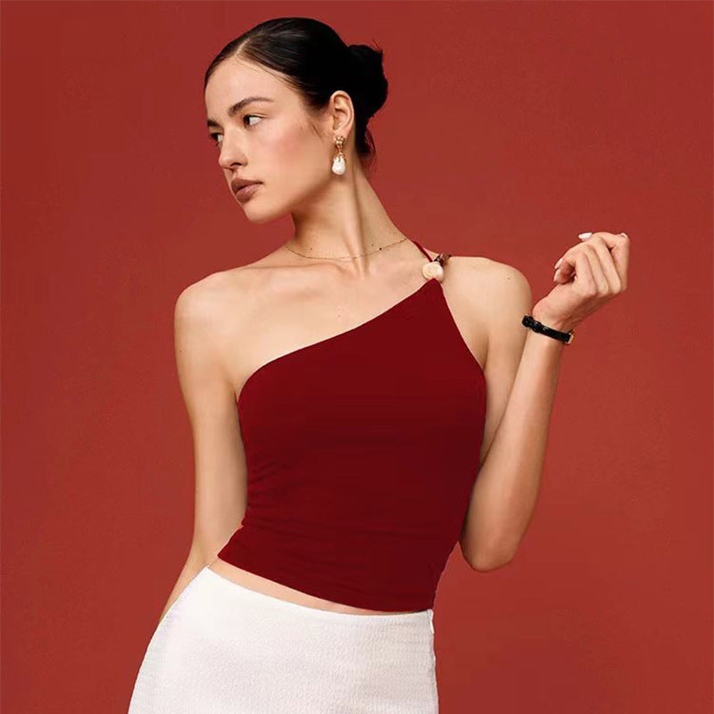 Red yoga tank top with single-shoulder strap and gemstone accent at the strap.