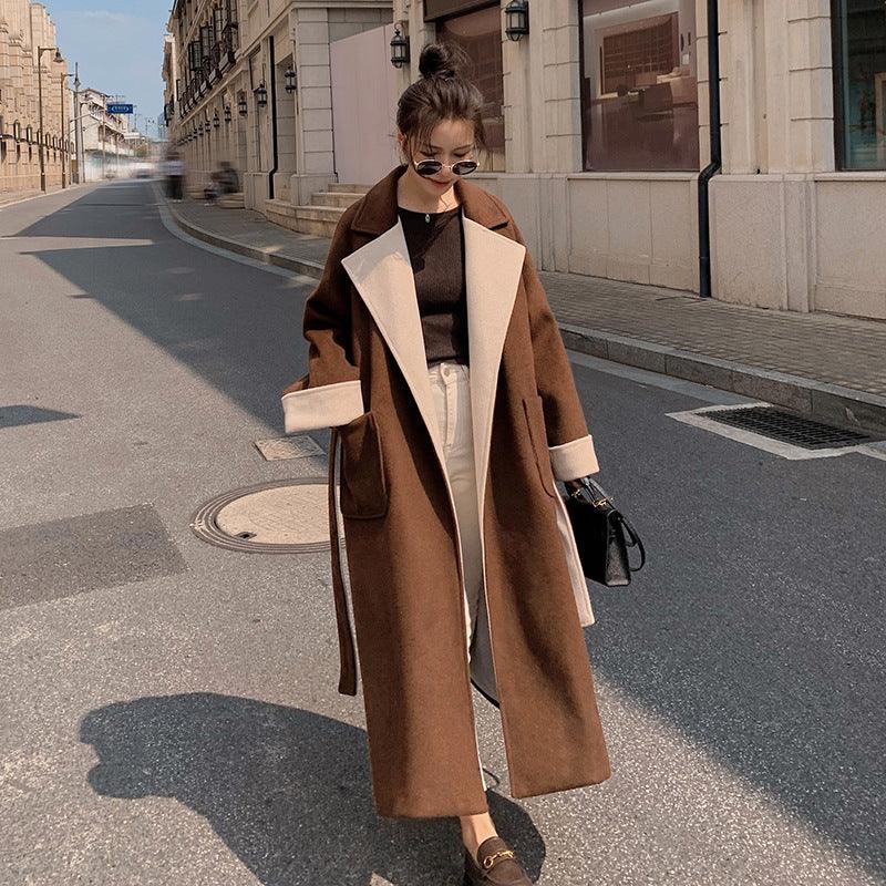 Women's long brown wool coat with cream contrast lapel and cuffs, belted waist