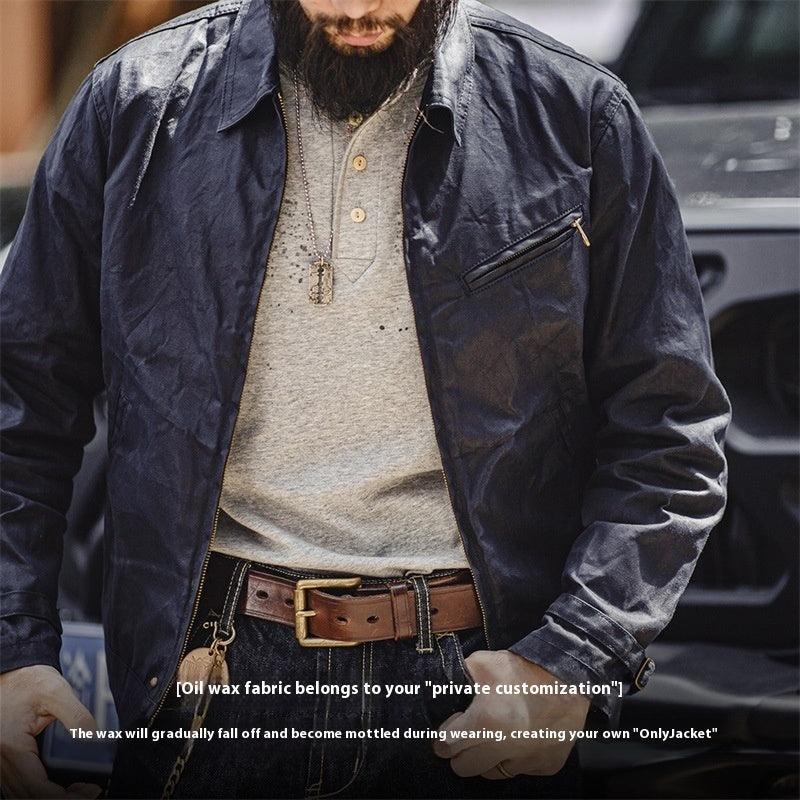 Dark blue canvas oil wax jacket with zip front, stand collar, and chest zipper pocket.