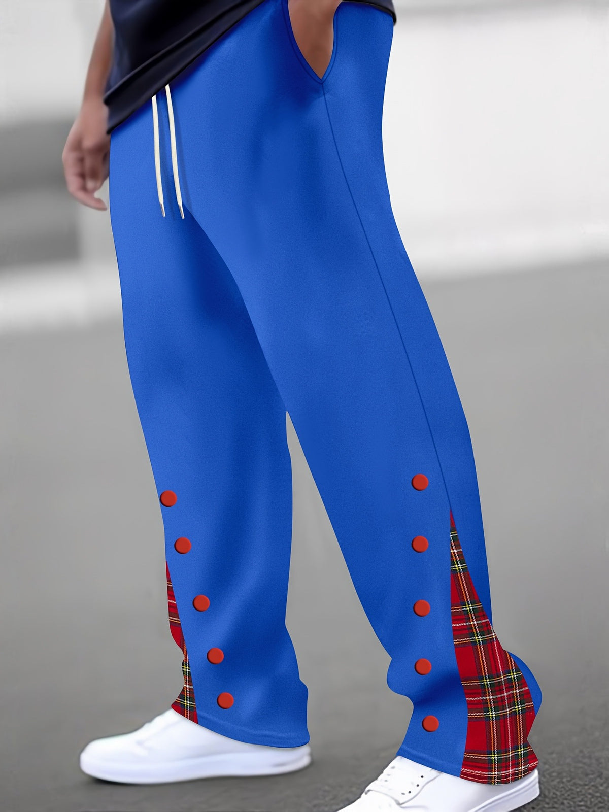 Blue color-block trousers with red dot accents and red tartan side panel