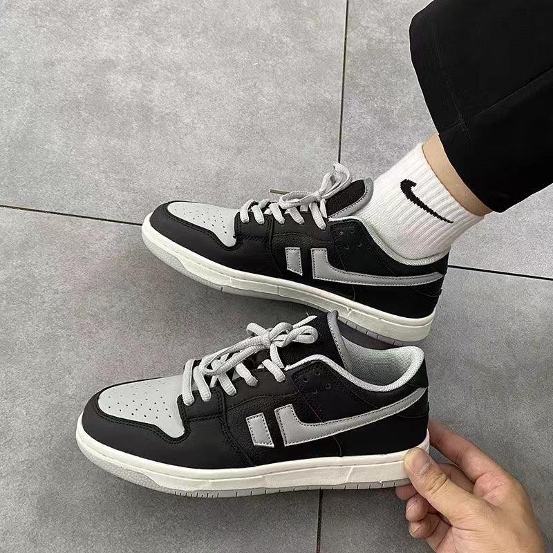Black and gray low-top platform sneakers with white laces and light sole