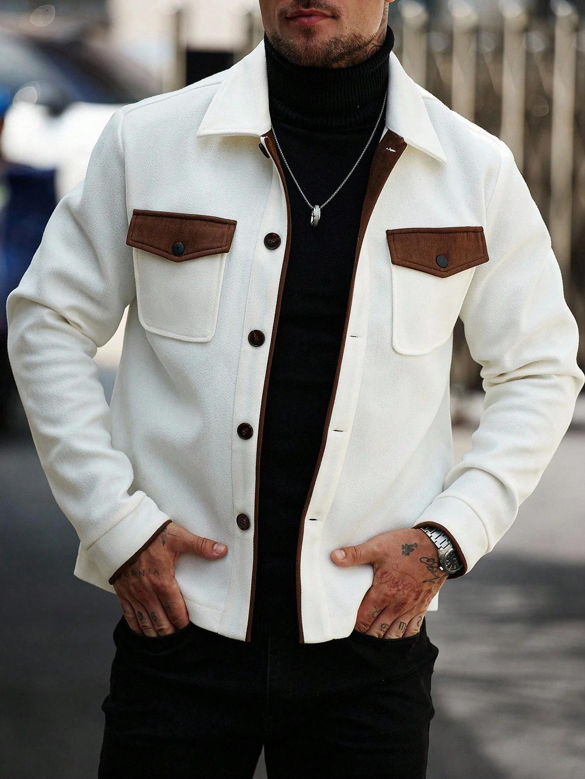 White wool workwear jacket with brown flap chest pockets and dark button placket.