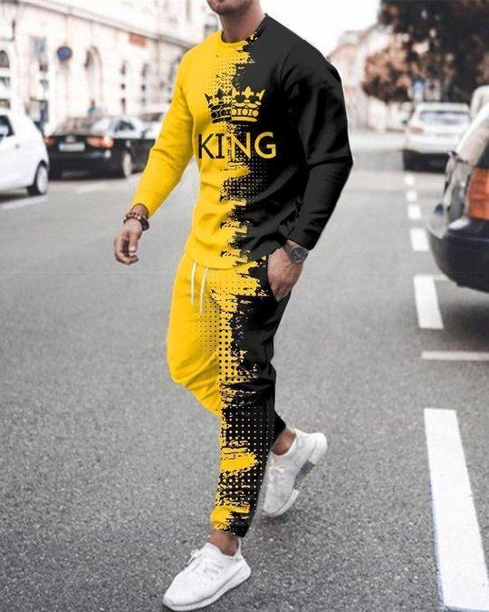 Full body view: yellow and black crewneck sweater with KING graphic, track pants
