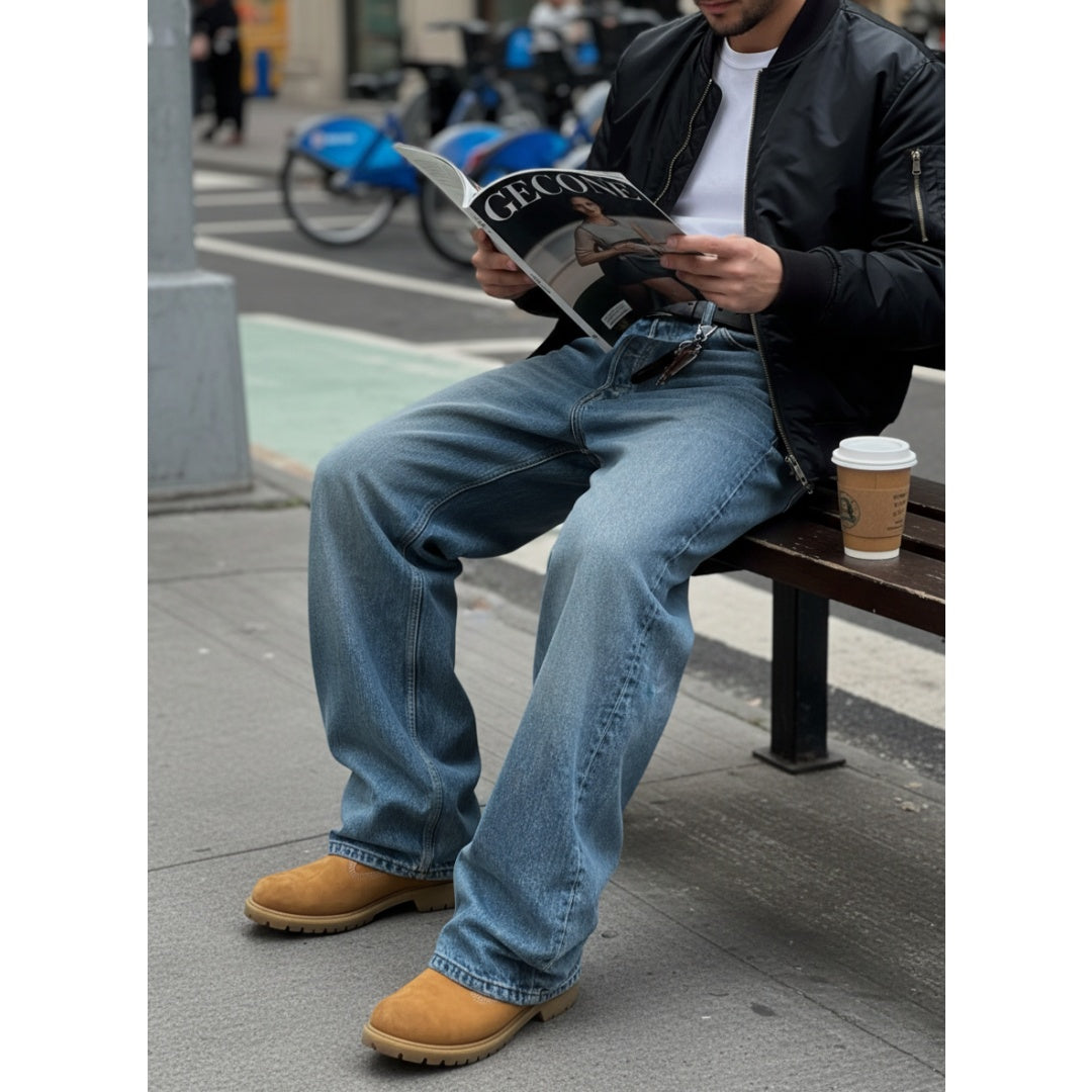Light blue straight-leg denim pants with belt loops and back pockets, seated view
